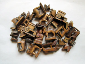 Image of engraved wooden figurines made by laser cutting, arranged artistically.