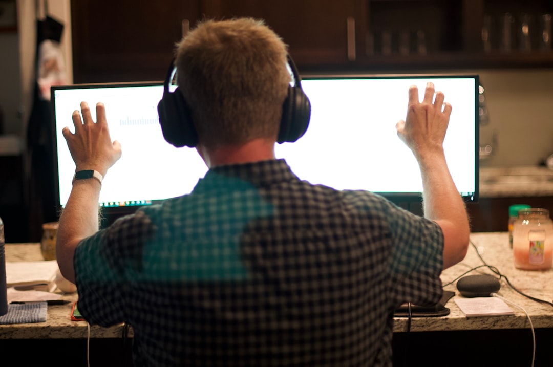 man in blue and white plaid shirt wearing black headphones, Working from Home with Headphones On