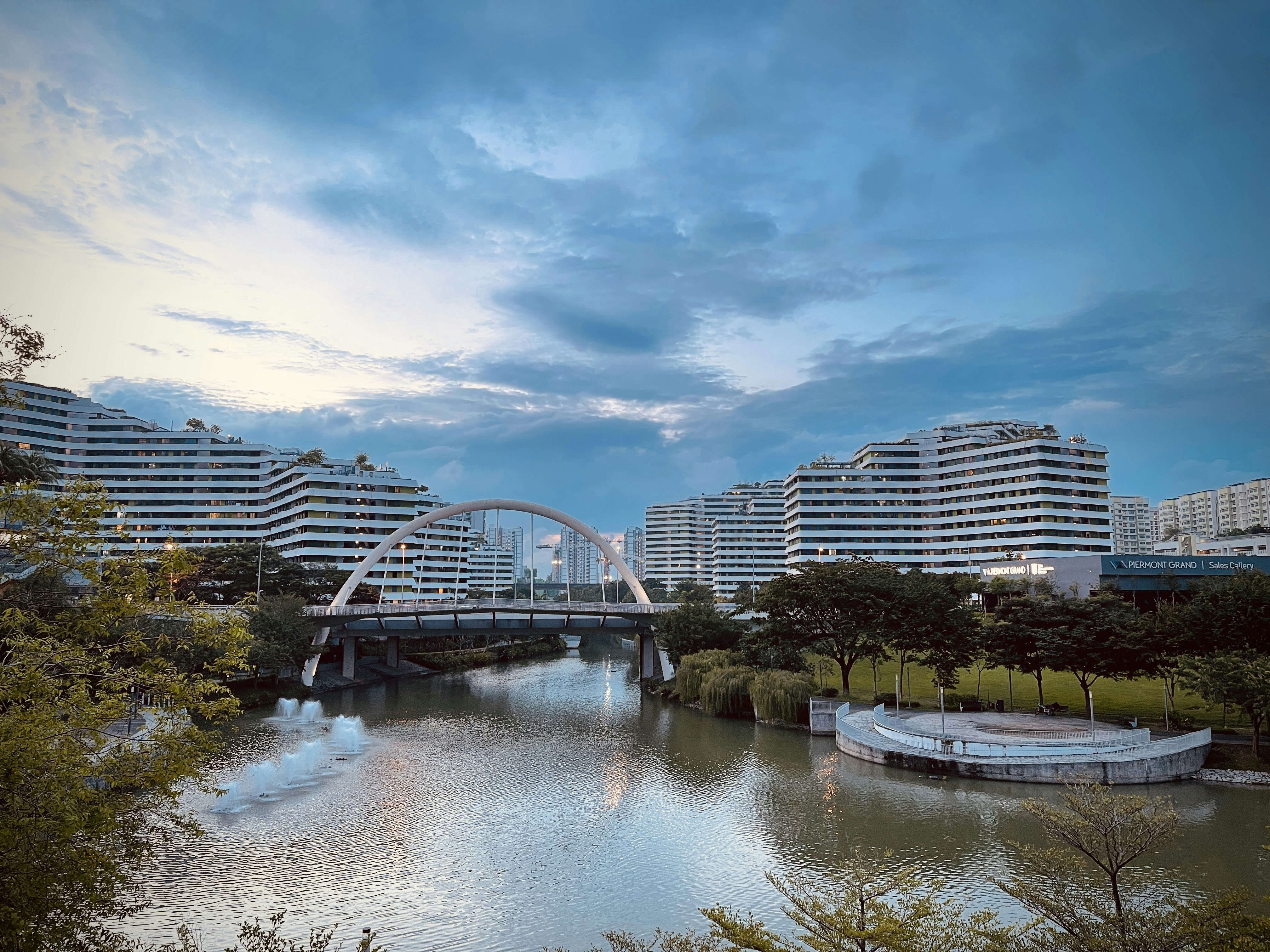 white bridge over river near city buildings during daytime