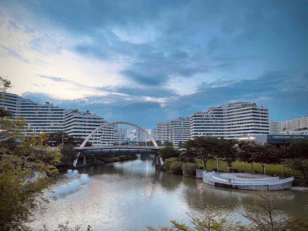 white bridge over river near city buildings during daytime