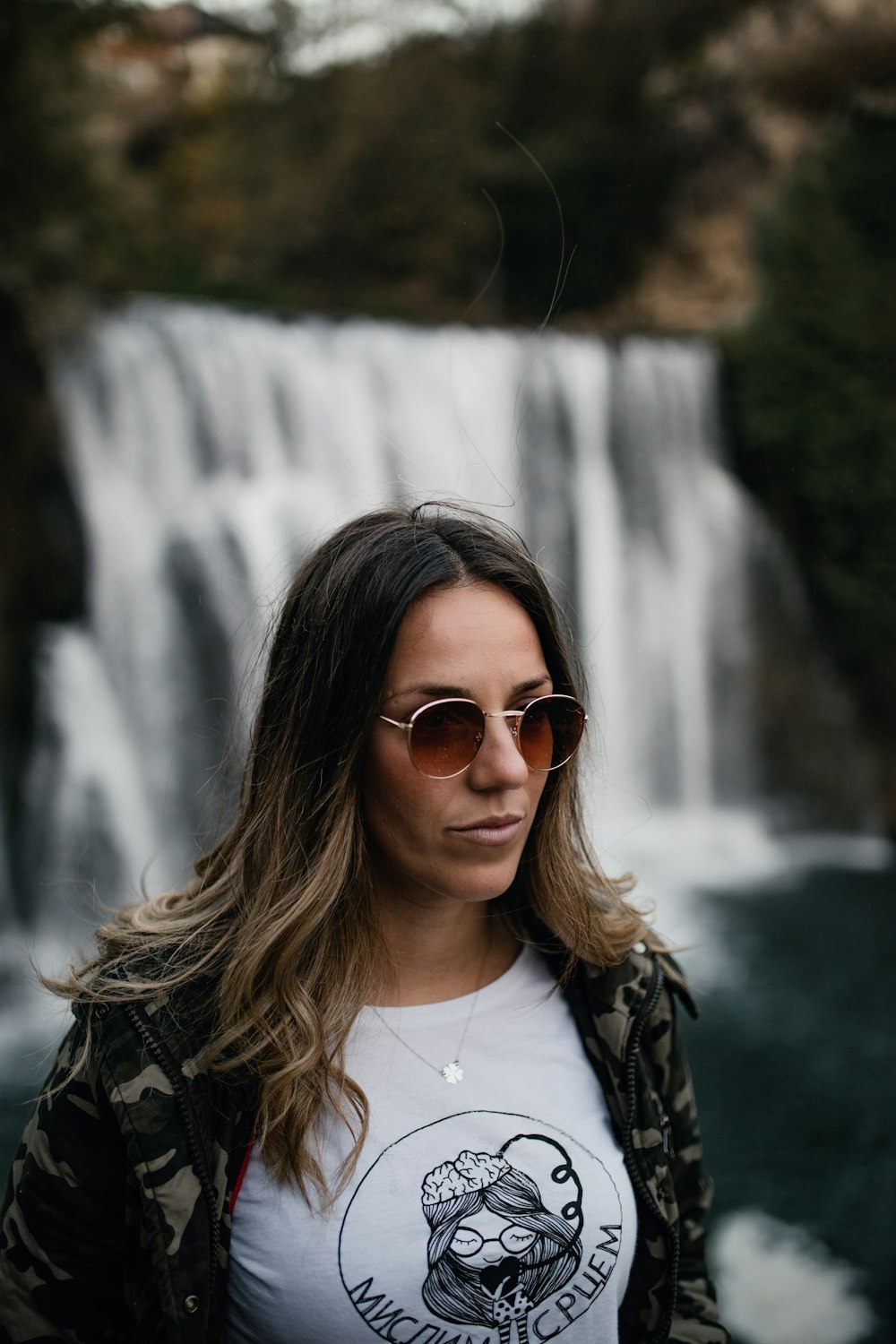 woman in black jacket wearing brown sunglasses