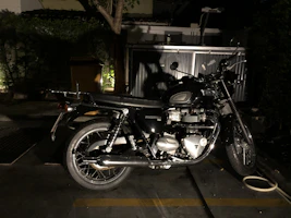 A classic vintage motorcycle with polished chrome details under soft daylight.