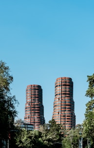 green trees beside brown concrete building during daytime