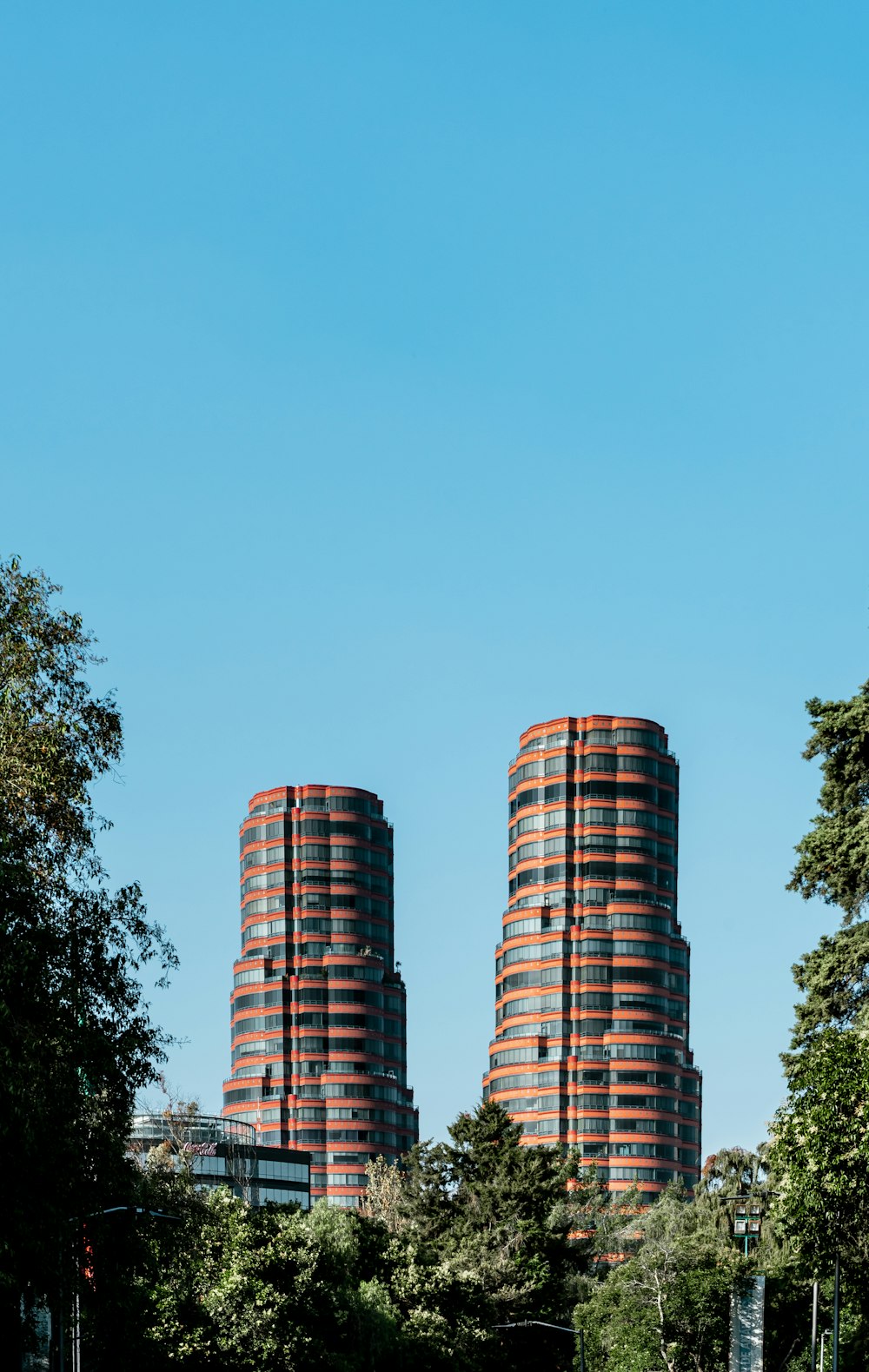 green trees beside brown concrete building during daytime