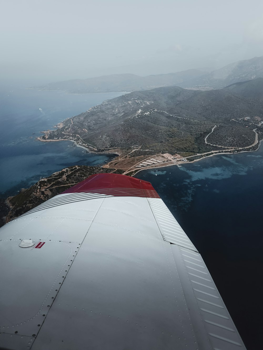 aerial view of mountains and body of water during daytime