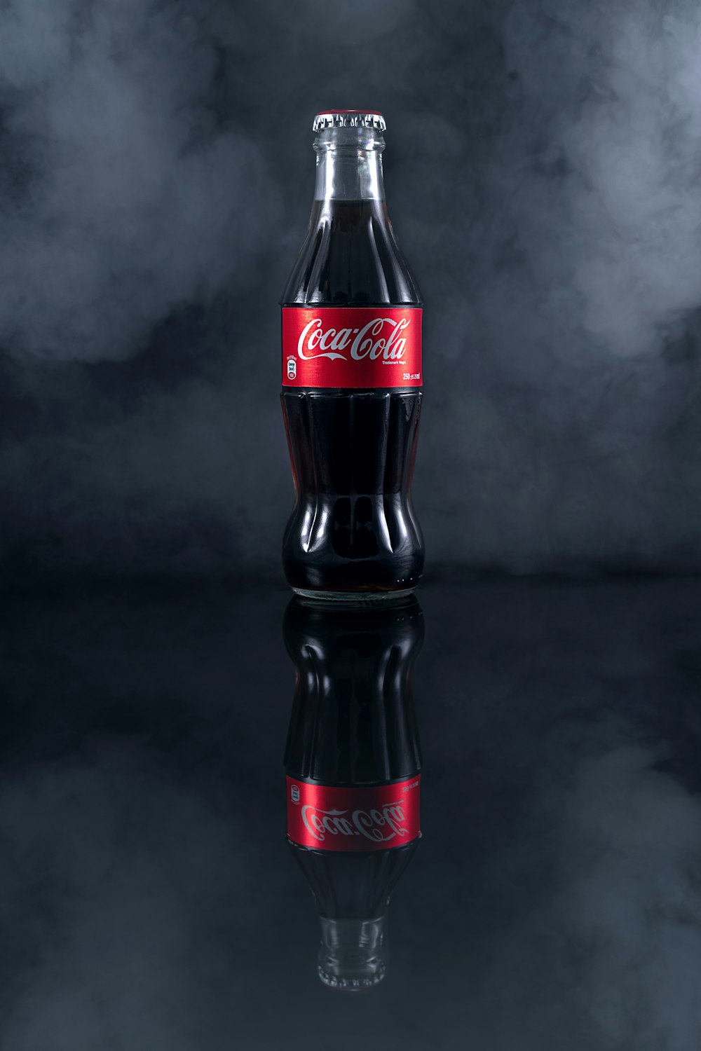 coca cola bottle on black table