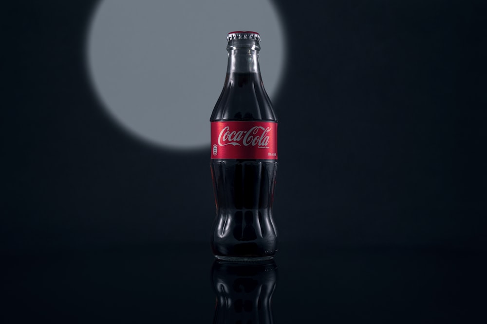coca cola bottle on black surface