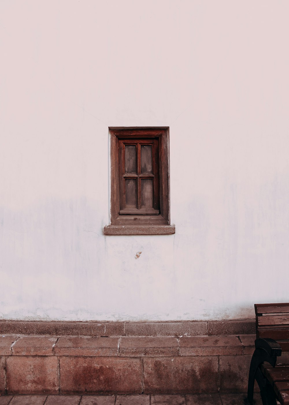 brown wooden window on white concrete wall