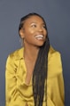 woman in yellow button up shirt wearing black and white scarf