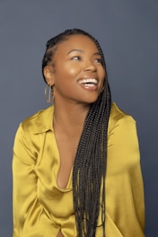 woman in yellow button up shirt wearing black and white scarf