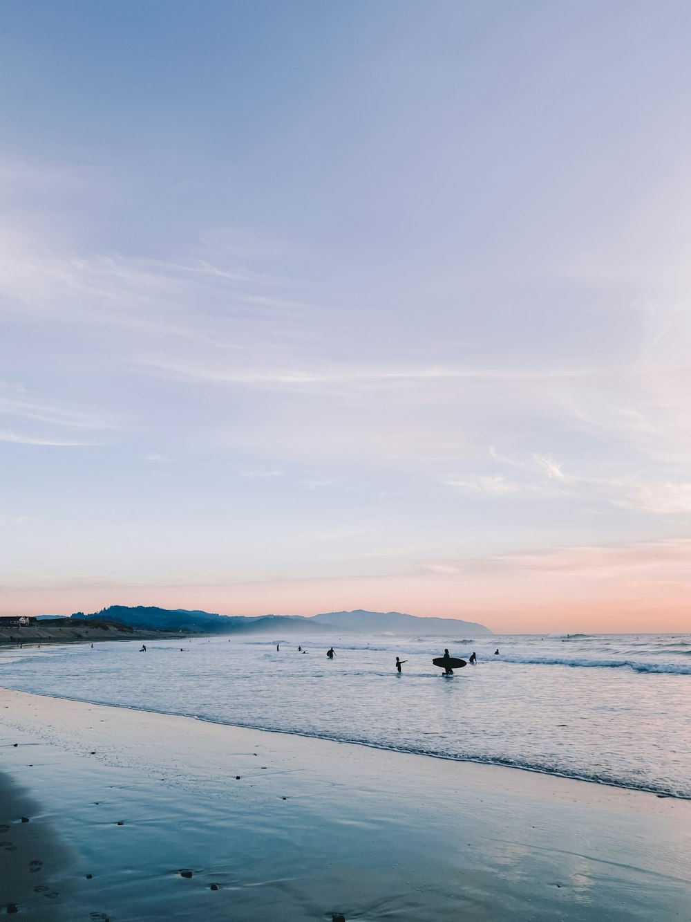 person in black shirt standing on beach during daytime