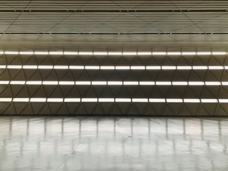 Spacious event room with minimalist decor and elegant lighting.