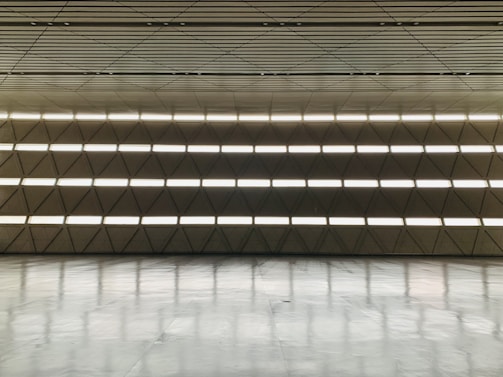 Spacious, tranquil interior with wide margins, warm light, and elegant black structural elements.