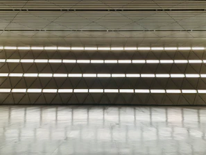 Spacious commercial interior featuring sleek, high-end flooring with warm tones.