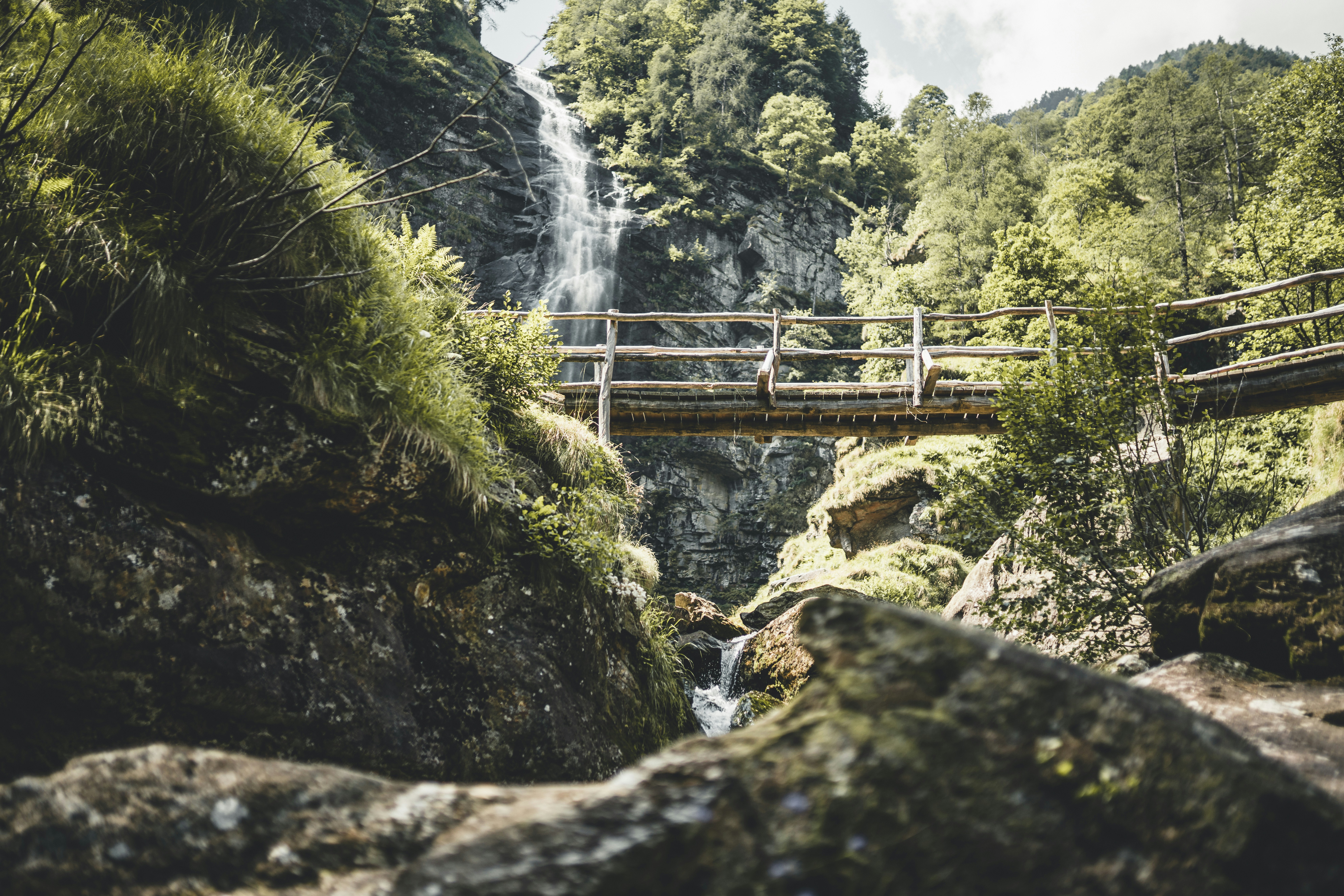 brown wooden bridge over river