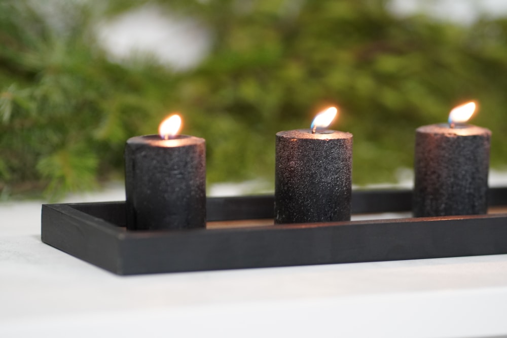 black candles on white table