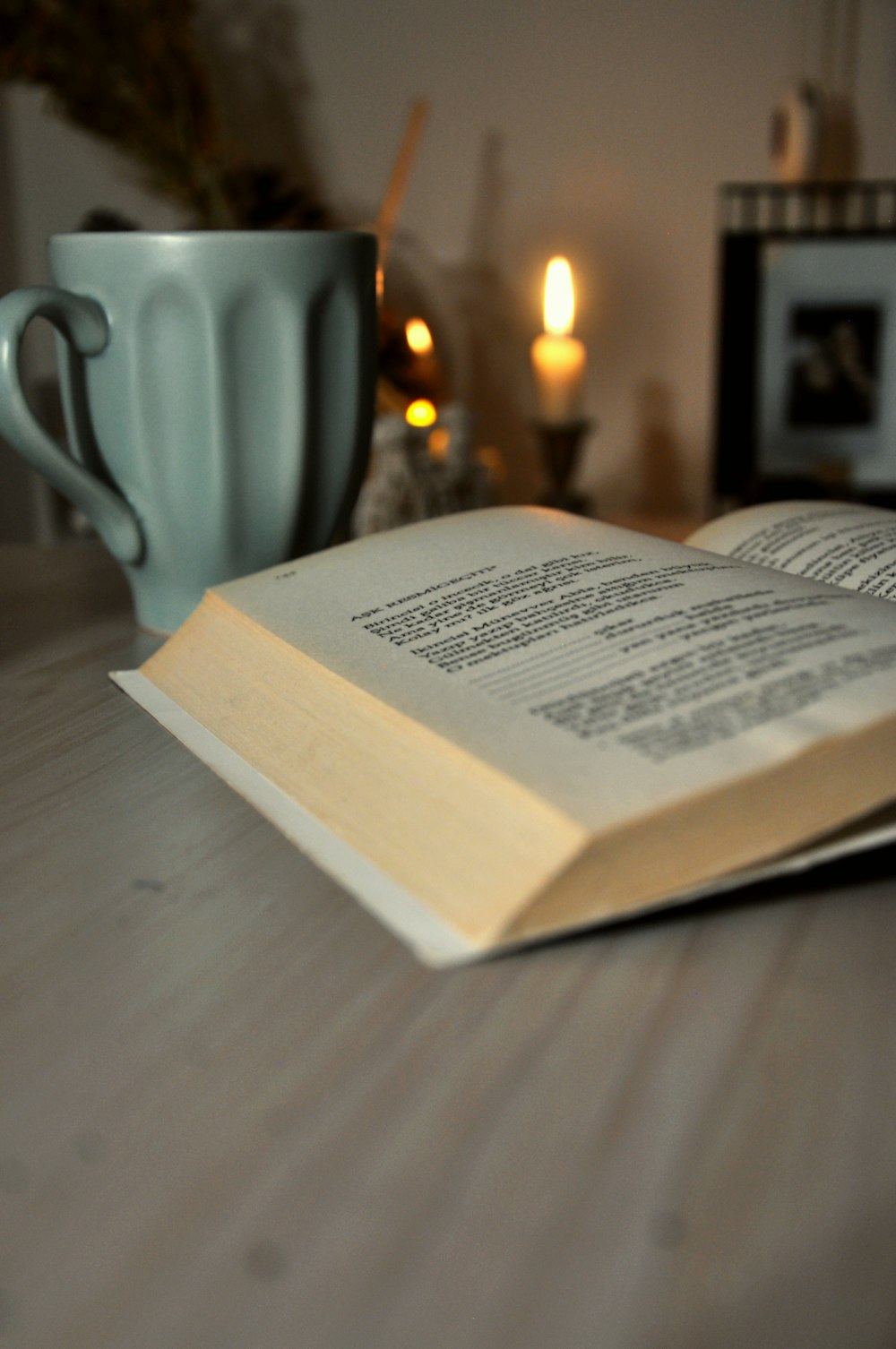 opened book on brown wooden table