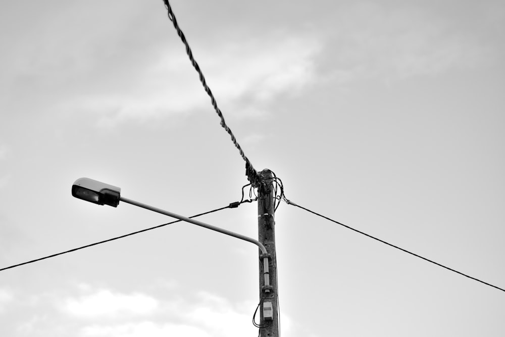 grayscale photo of electric post