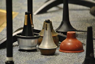 Various mouthpieces lined up, showing different stages of custom modification.