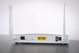 A variety of modern modems and routers displayed on a wooden table.
