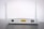 A white Wi-Fi router with two antennas positioned vertically. The router is seen from the back, showing ports and connectors including Ethernet ports, a power switch, and a power input. The device is placed on a dark surface against a light background.