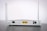 A white Wi-Fi router with two antennas positioned vertically. The router is seen from the back, showing ports and connectors including Ethernet ports, a power switch, and a power input. The device is placed on a dark surface against a light background.