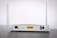 A white Wi-Fi router with two antennas positioned vertically. The router is seen from the back, showing ports and connectors including Ethernet ports, a power switch, and a power input. The device is placed on a dark surface against a light background.