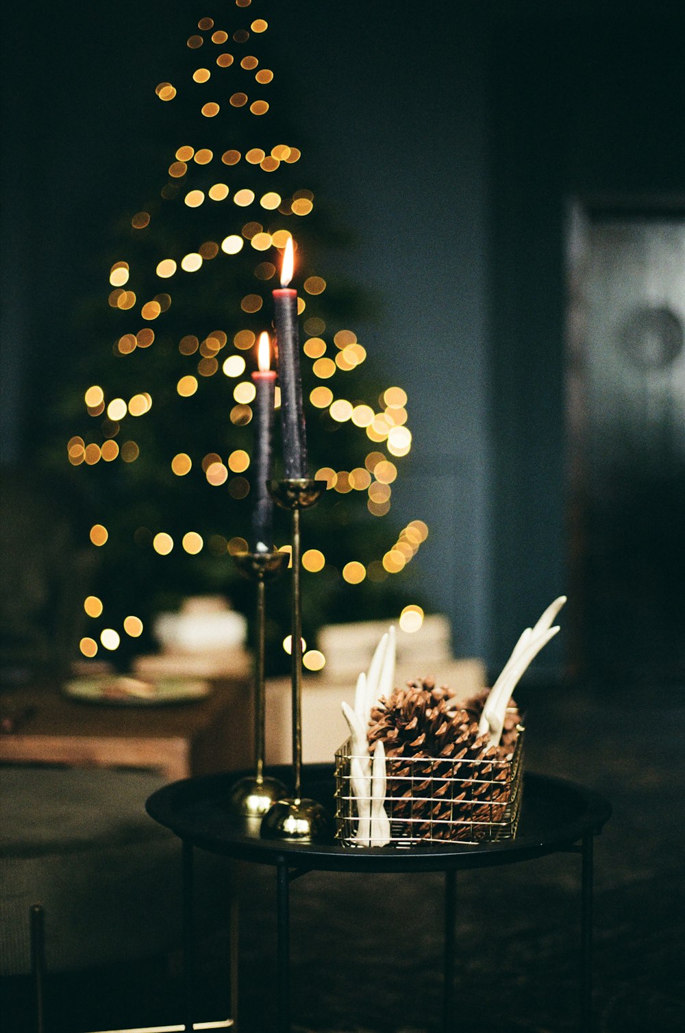 lighted candle on black metal holder