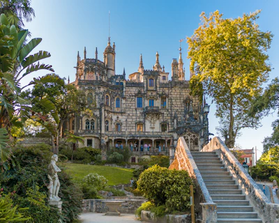 Elegant historic mansion with intricate stonework and lush gardens.