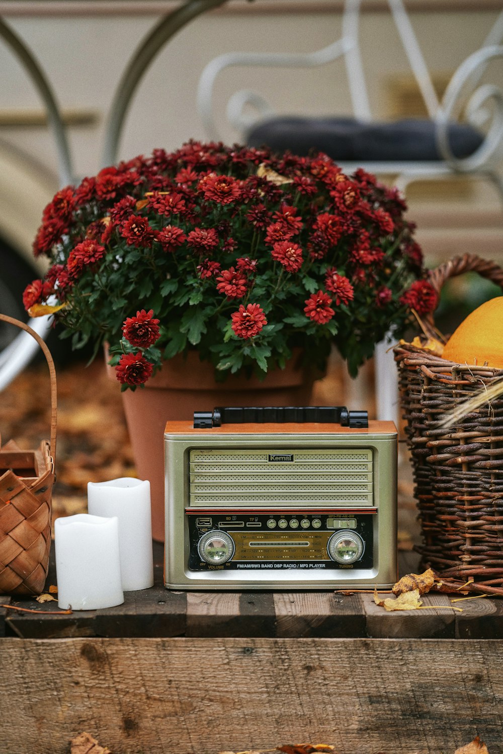 brown and gray radio beside brown wicker basket with red flowers