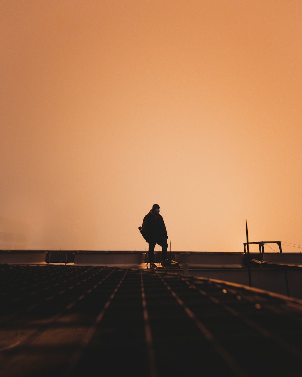 silhouette of person walking on sidewalk during daytime