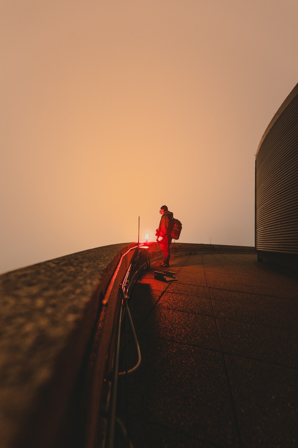 man in red shirt and pants sitting on the ground