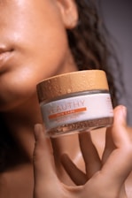 woman holding coconut oil bottle