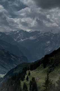green and black mountains under white clouds during daytime