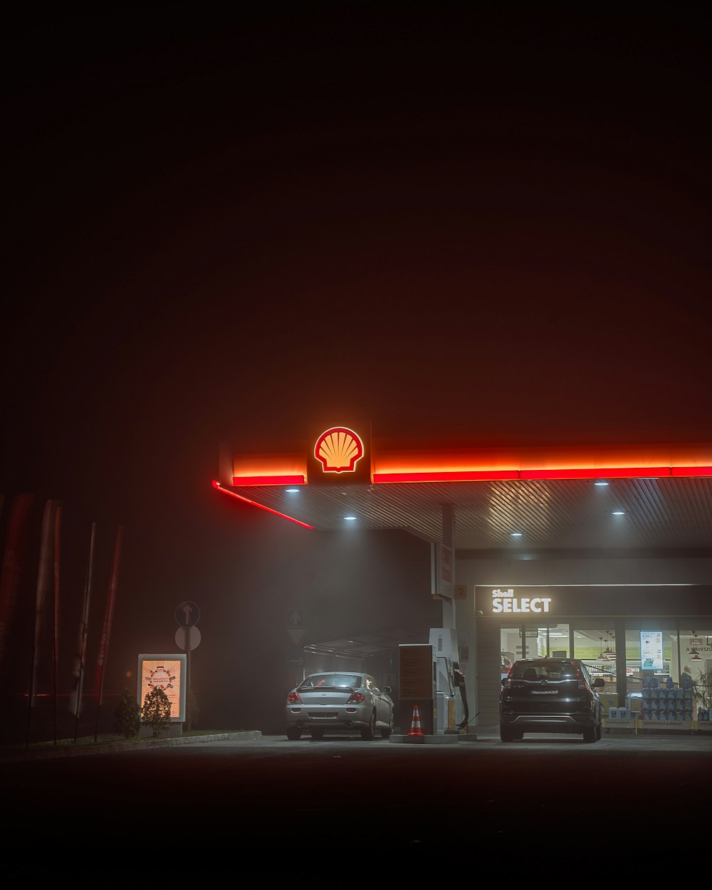 cars parked in front of store during night time