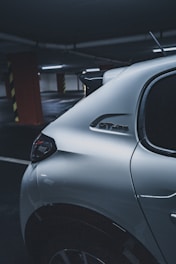silver car parked near red building