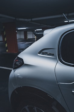 silver car parked near red building