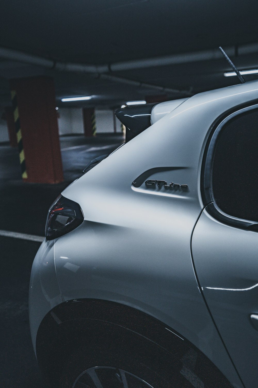 silver car parked near red building