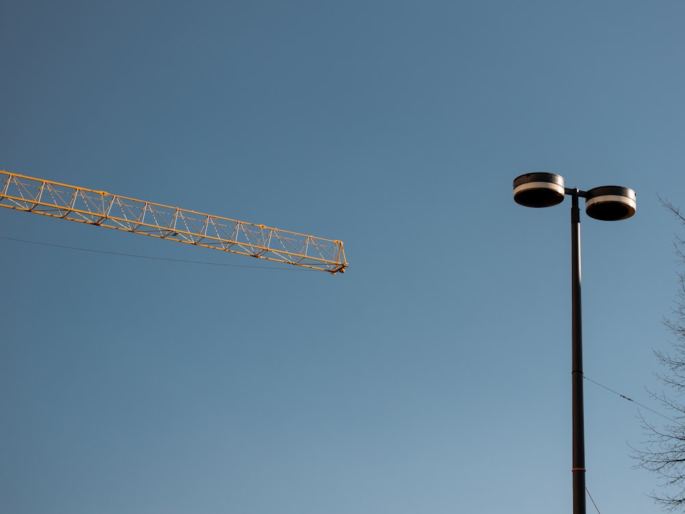 white and red crane under blue sky during daytime