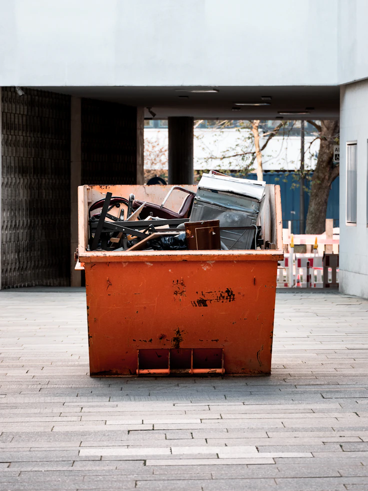 Junk removal workers clearing furniture