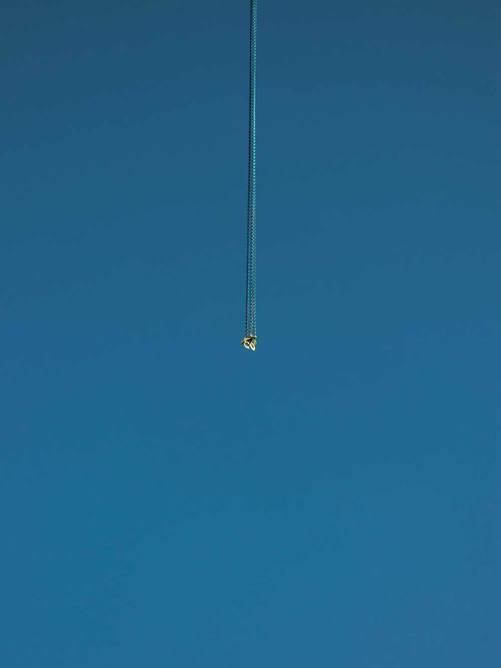 black and silver fishing rod under blue sky during daytime