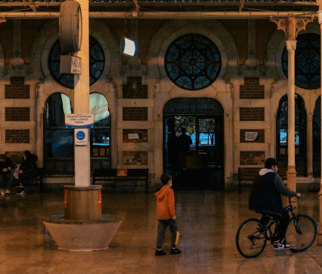 woman in black jacket standing near bicycle