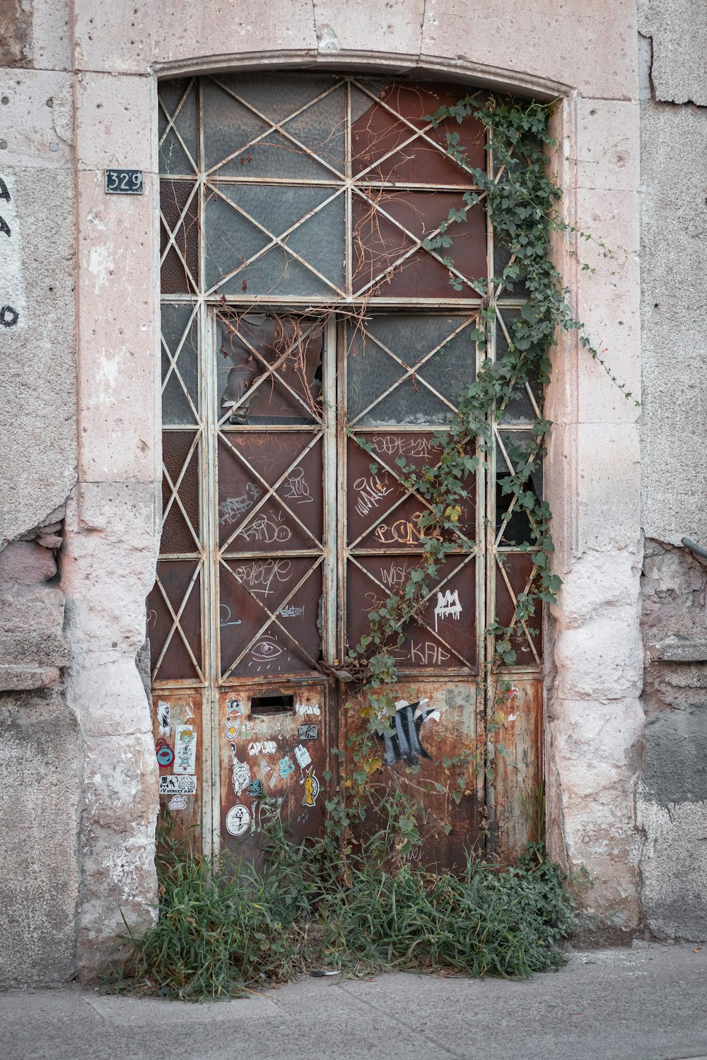 red wooden door on gray concrete wall