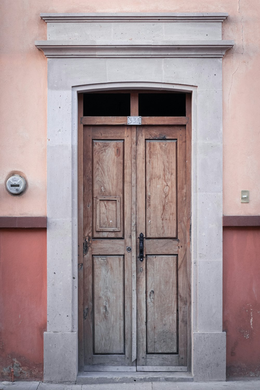 puerta de madera marrón sobre pared de hormigón marrón