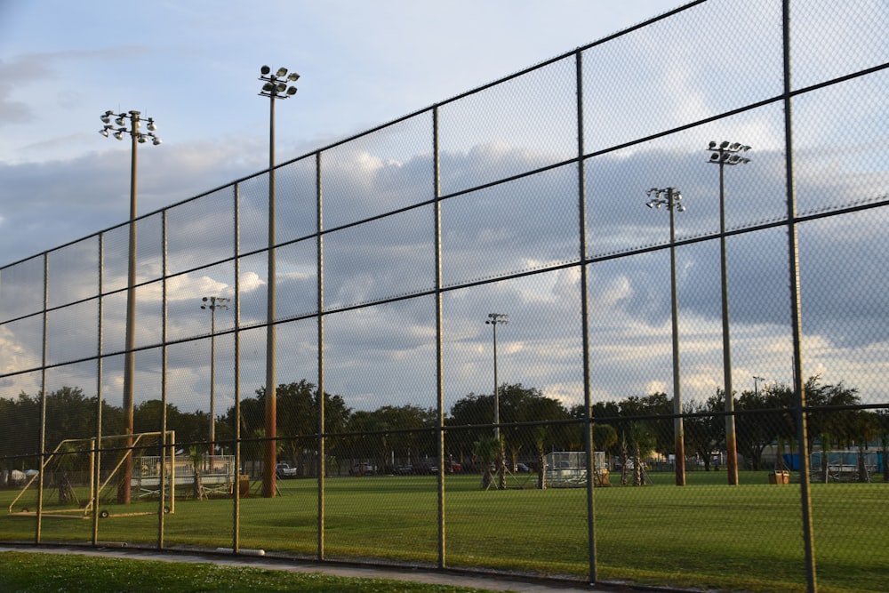 black metal fence on green grass field during daytime