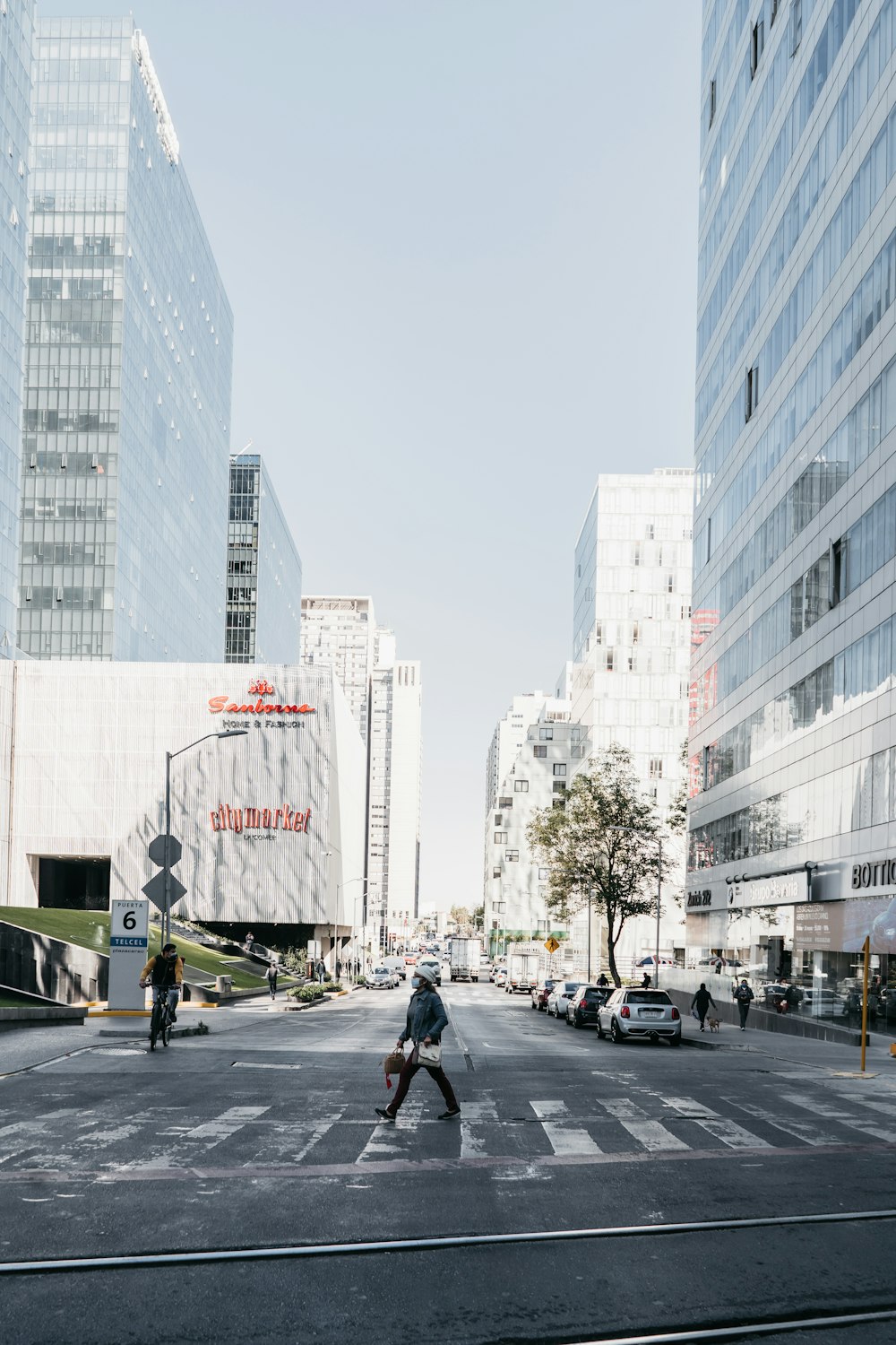 people walking on pedestrian lane near white concrete building during daytime