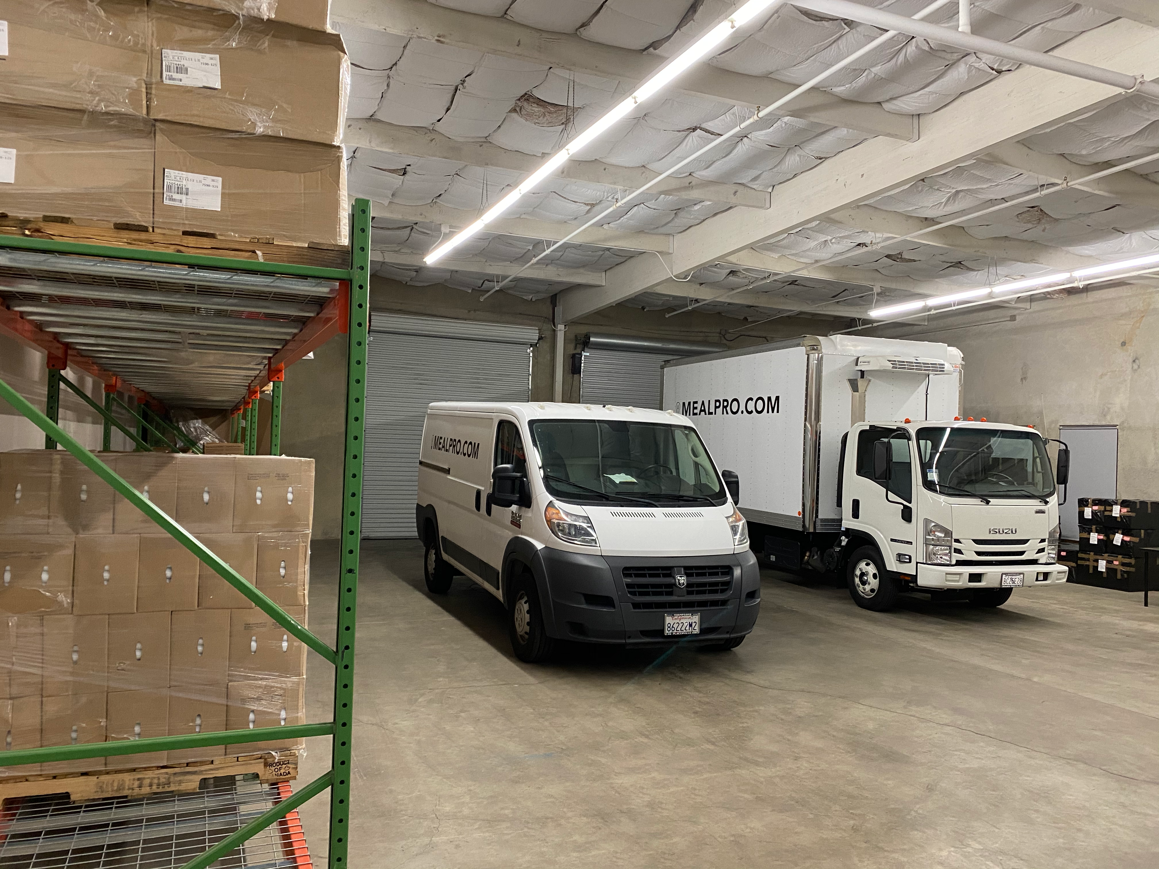 Neatly stacked cardboard boxes inside a clean white delivery van ready for transport