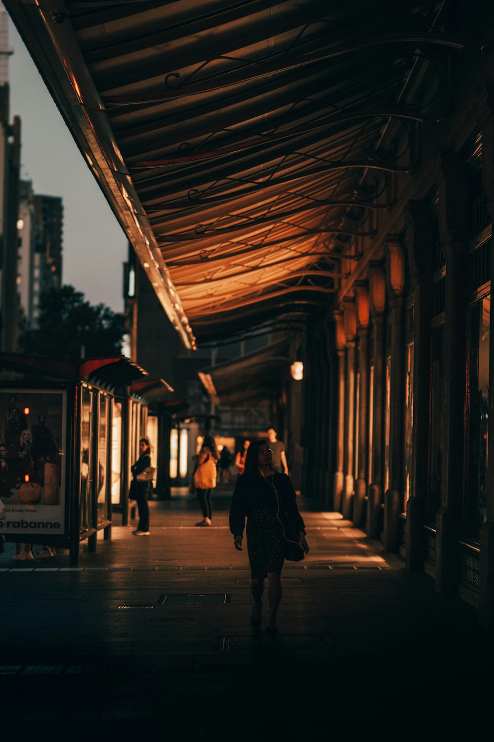 people walking on sidewalk during night time