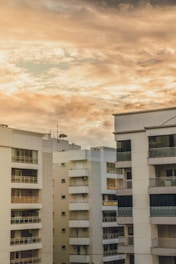 white concrete building under cloudy sky during daytime