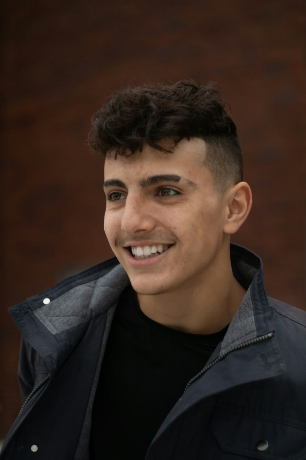 man in black leather jacket smiling